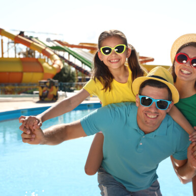 Happy family at water park. Summer vacation